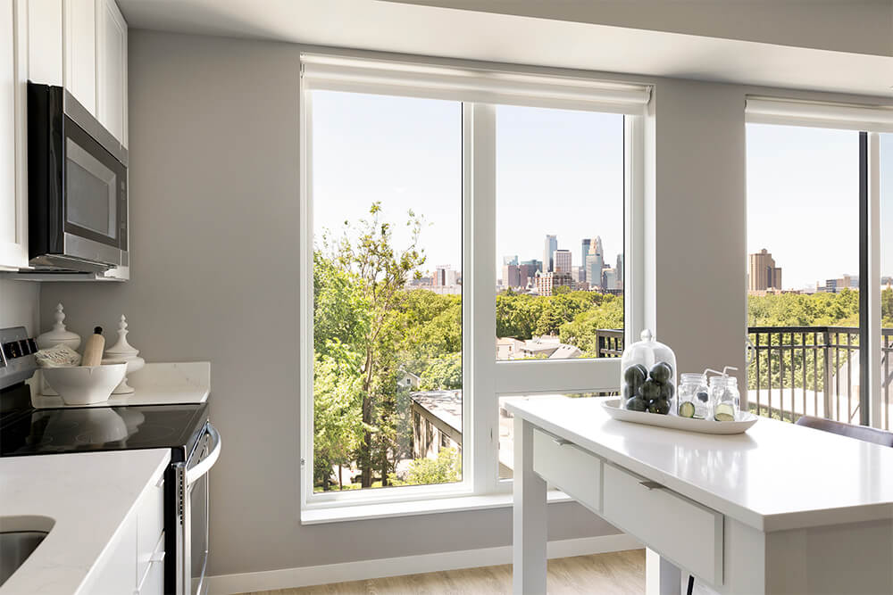  Kitchen with a view of the cityscape through large windows.